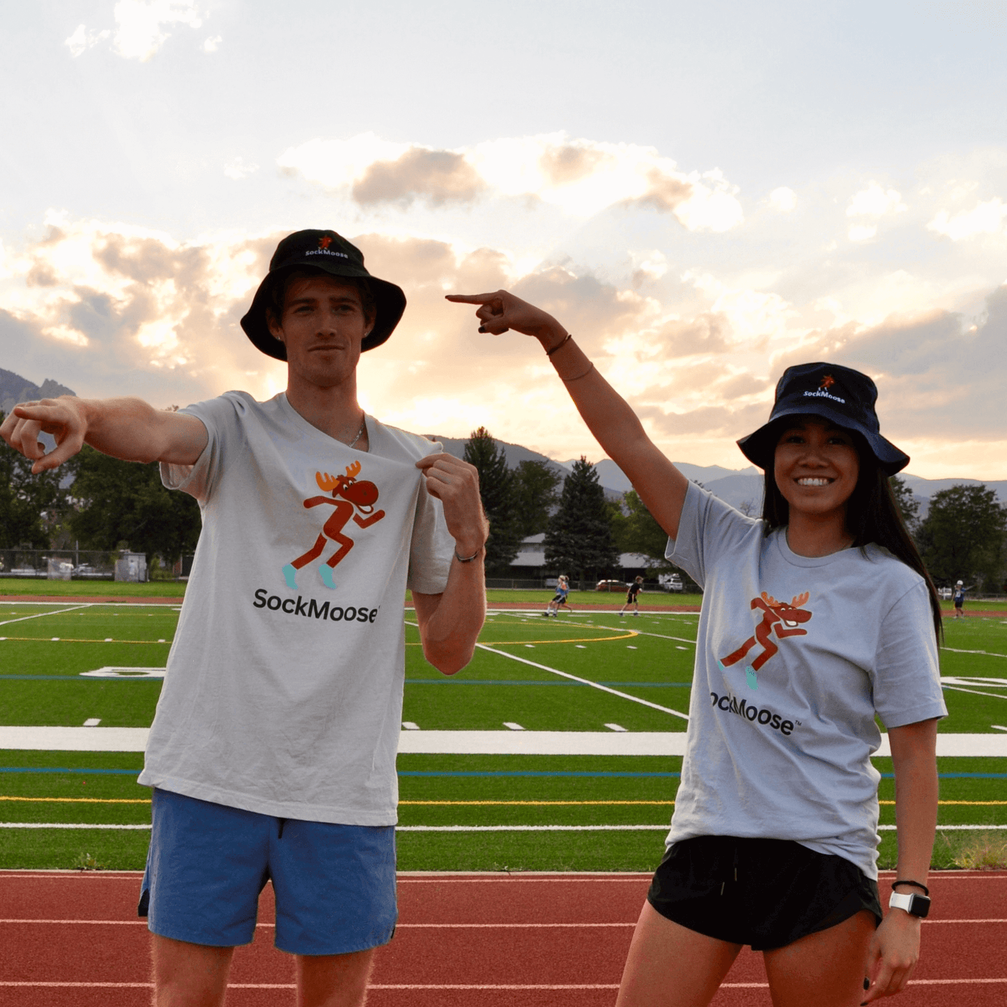 Male and female runner wearing SockMoose running socks bucket hat with cartoon moose logo