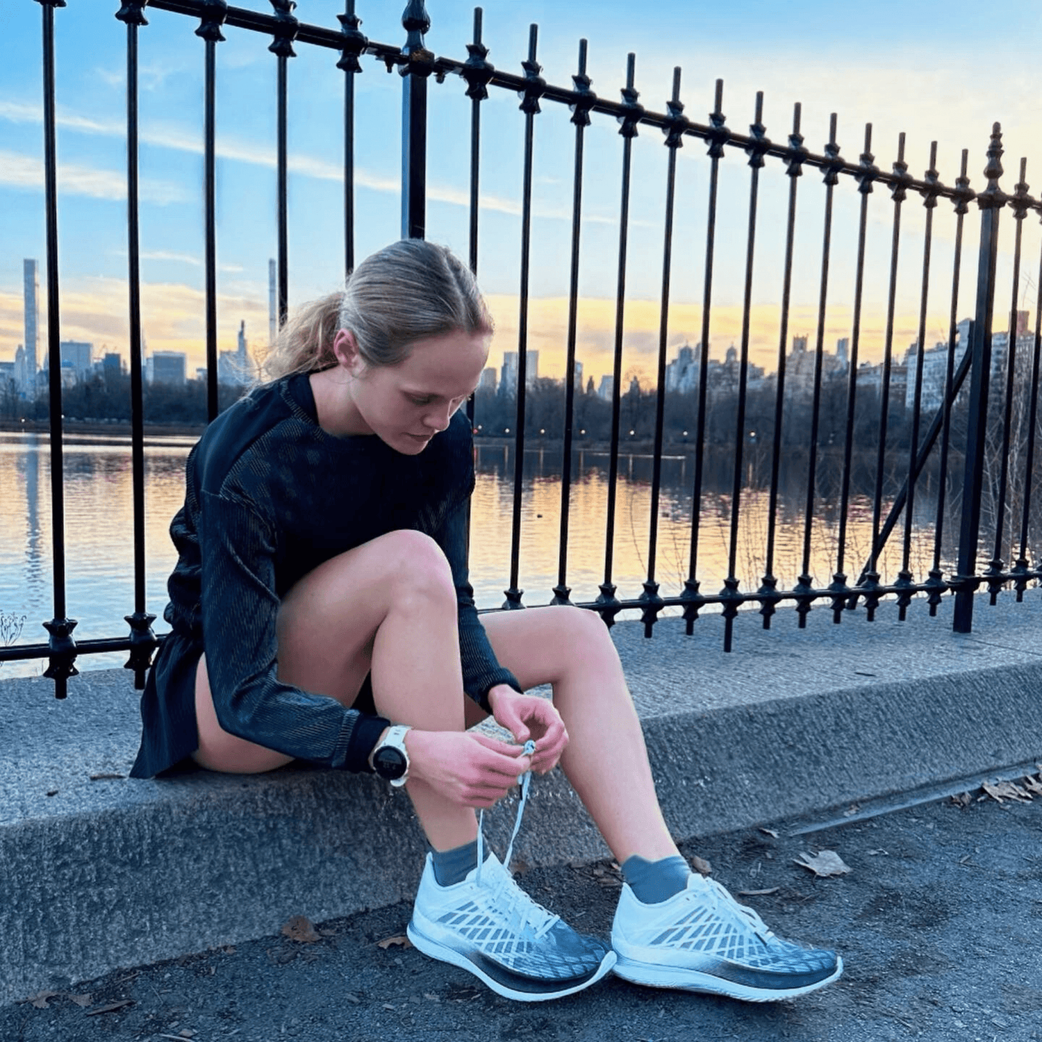 Female runner wearing gray SpeedyMoose ankle tab running socks