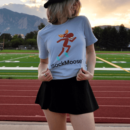 Female runner wearing SockMoose running socks light blue graphic t shirt with cartoon moose logo