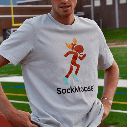 Male runner wearing SockMoose running socks silver graphic t shirt with cartoon moose logo