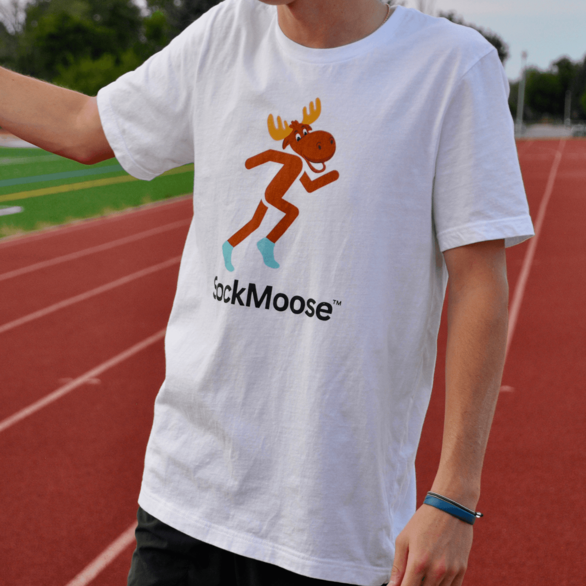 Male runner wearing SockMoose running socks white graphic t shirt with cartoon moose logo