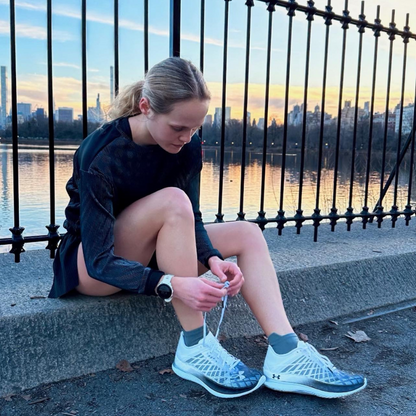 Female runner wearing SockMoose high performance running socks tying her shoes