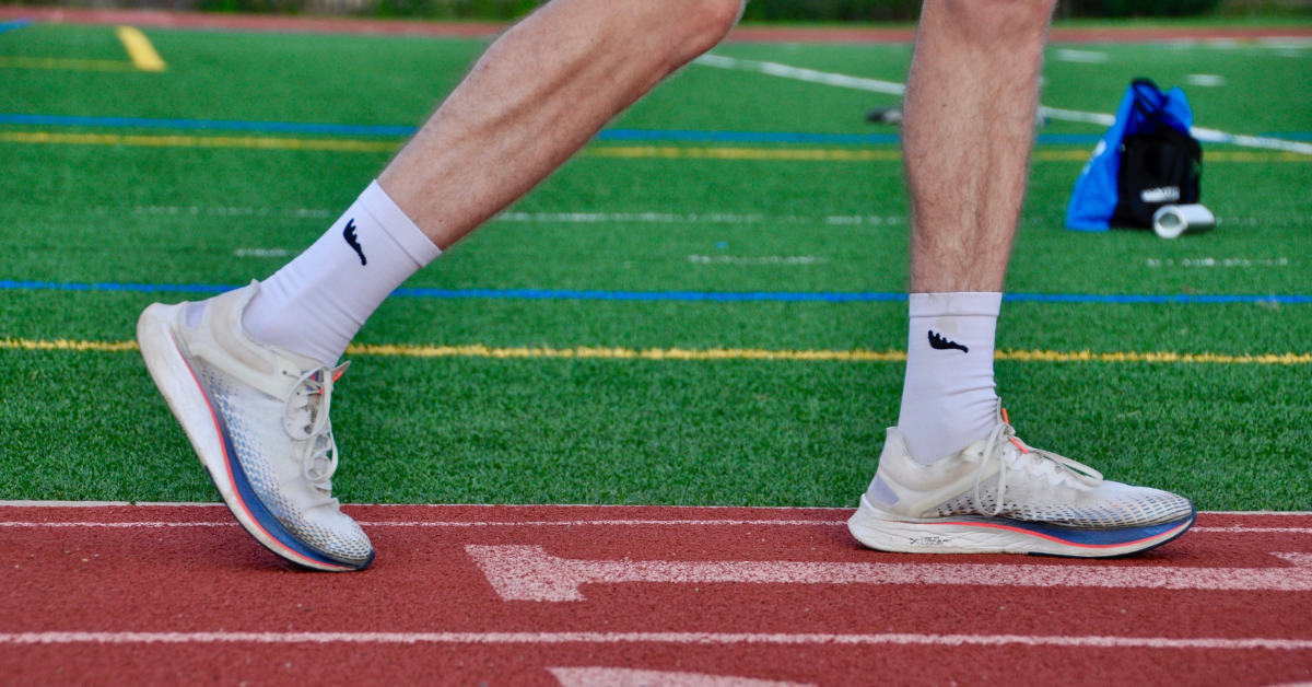 Lower legs of a male runner running in SockMoose SpeedyMoose crew length high performance, moisture wicking, blister resistant, running socks. 