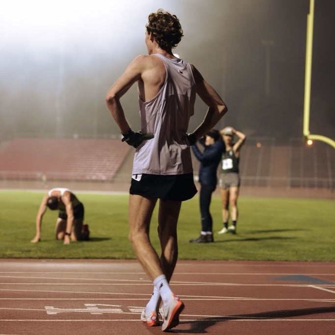 SockMoose crew length white running socks on a male runner who just finished a track race