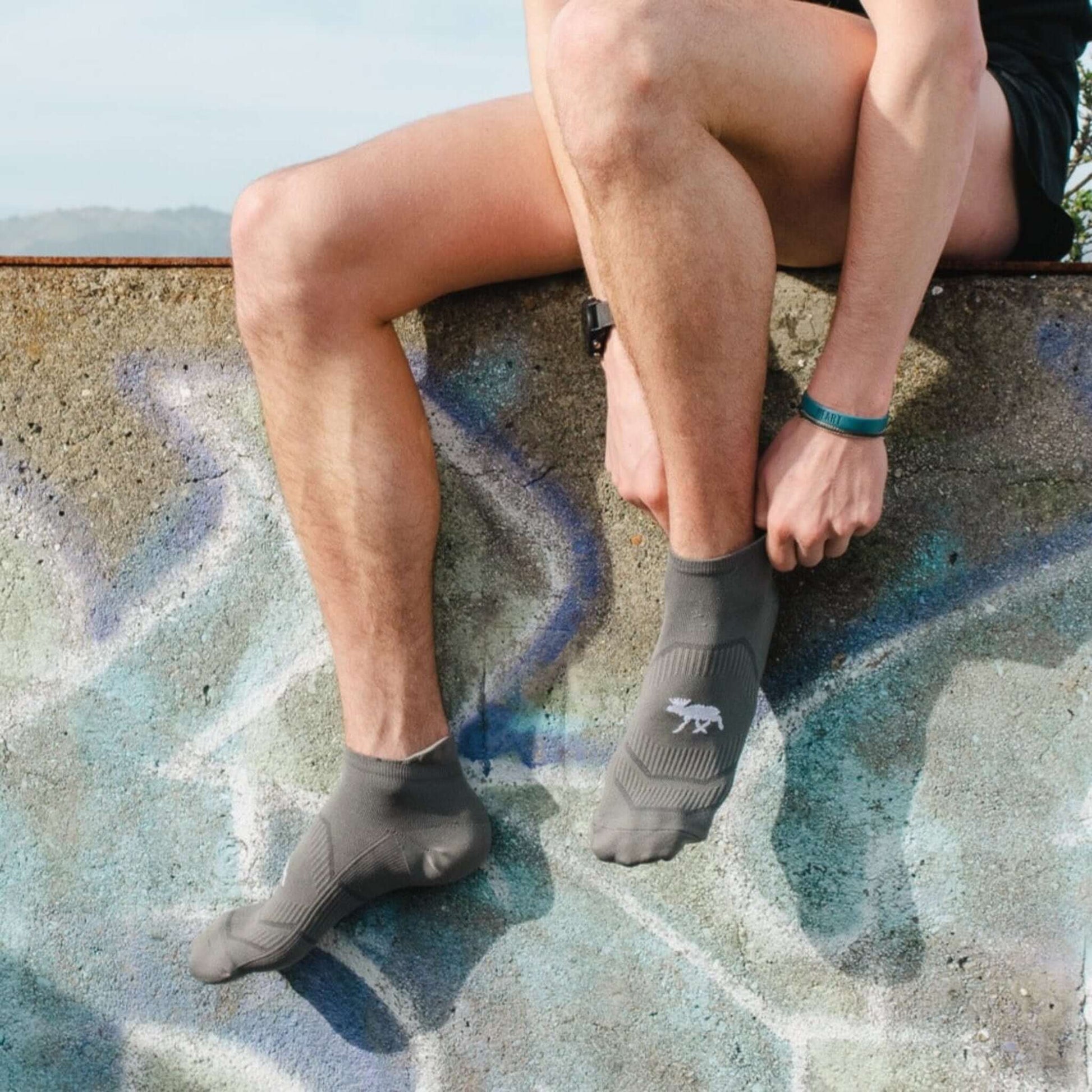 Grey high performance running sock - graffiti background